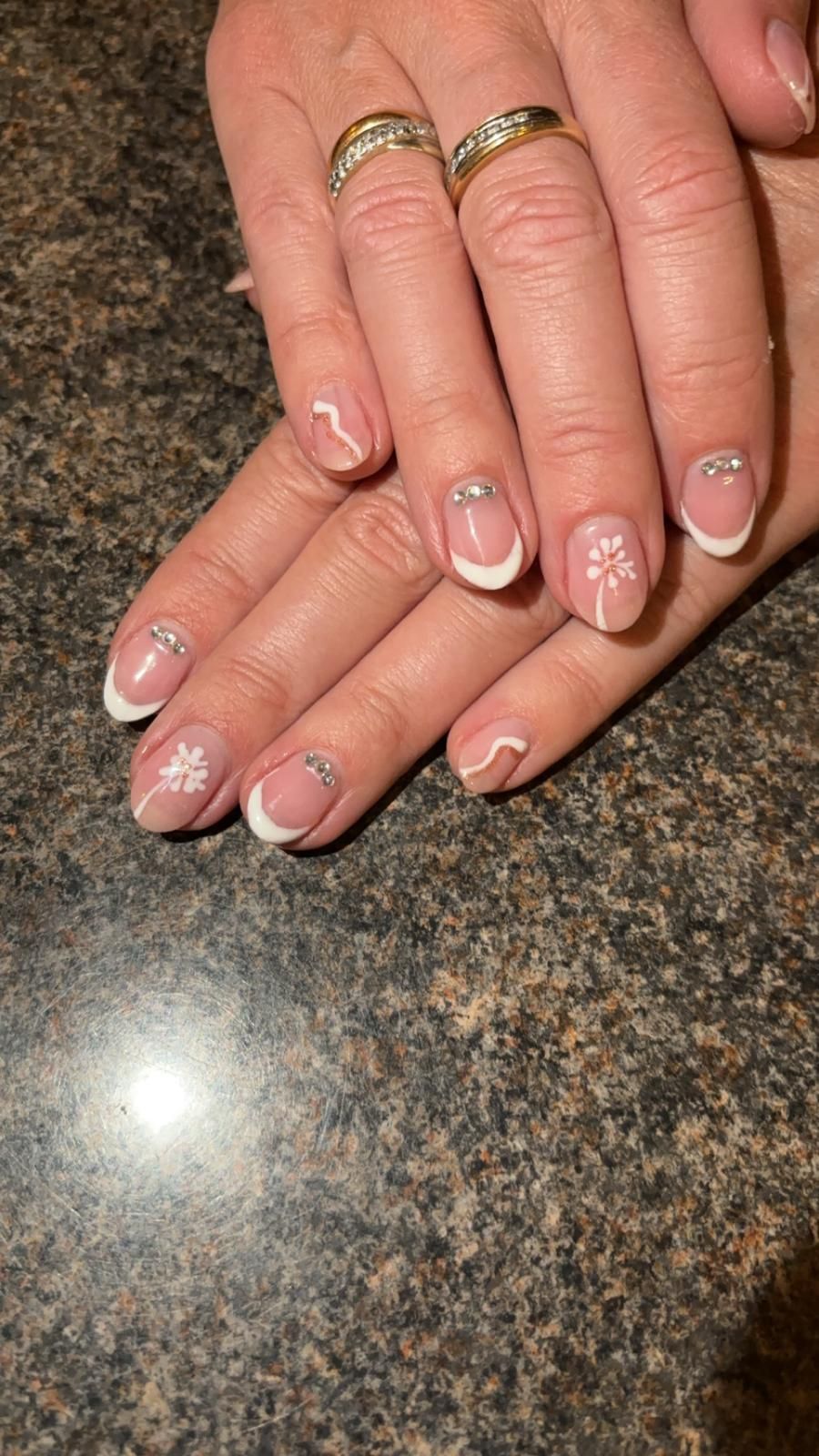 Soft nude French manicure with floral art and crystals