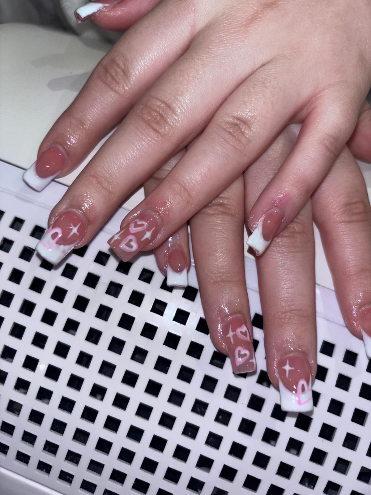 Pink French tip nails with hand-drawn hearts